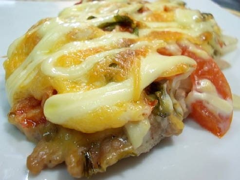 French meat in the oven with tomato, cheese and mushrooms