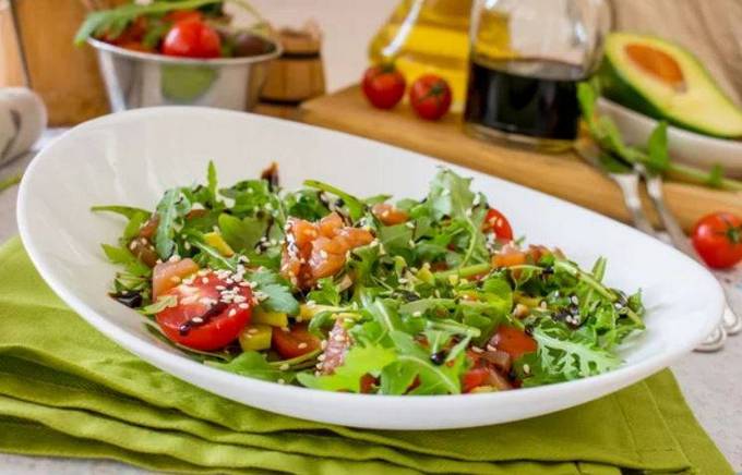 Salad with avocado, salmon and cherry tomatoes