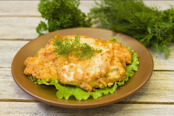 Chicken chops with cheese in a pan