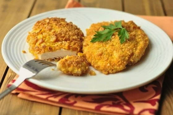 Chicken chops in a pan in bread crumbs