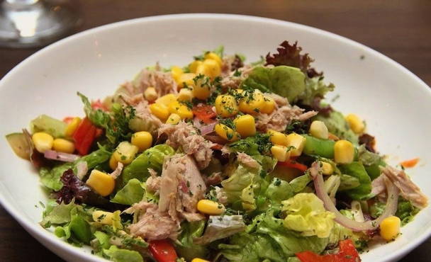 Salad with tuna, corn, tomatoes and avocado