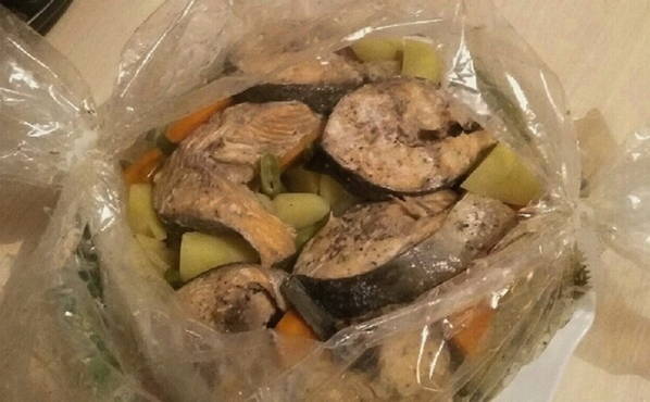 Pink salmon in a slow cooker with carrots and onions