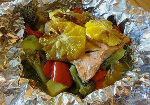 Pink salmon in foil on a vegetable pillow