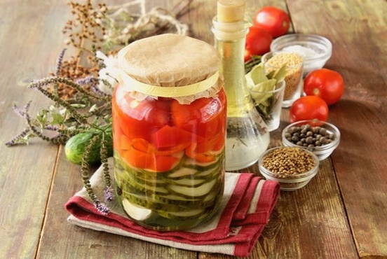 Assorted cucumbers and tomatoes for the winter in liter jars