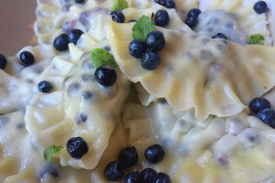 Dumplings with blueberries in milk