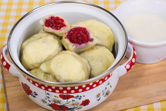 Dumplings with strawberries on yeast dough