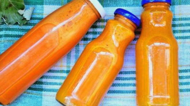 Carrot juice on a juicer for the winter