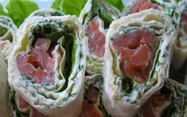 Lavash roll with red fish, melted cheese and salad