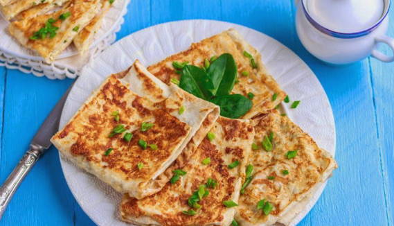 Lavash envelopes with cheese and herbs, fried in a pan