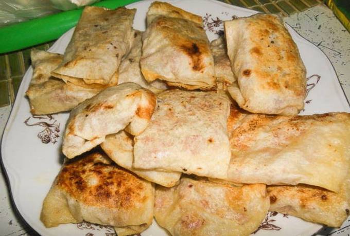 Lavash pies with cheese and sausage in a pan