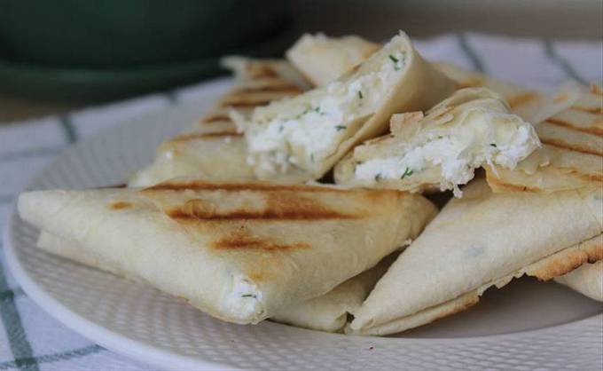 Lavash pies with cottage cheese and herbs in a pan
