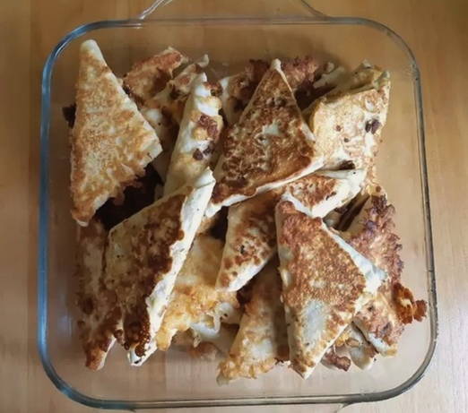 Lavash pies with cottage cheese and cheese in a pan