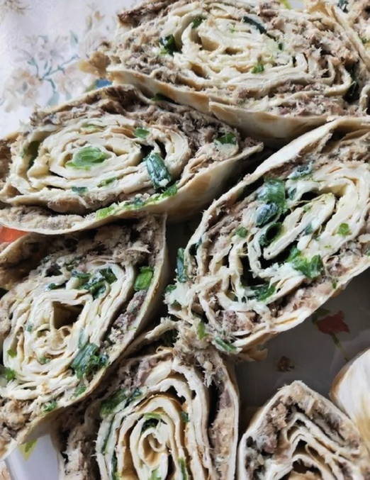 Lavash roll with canned fish, cheese, egg and herbs