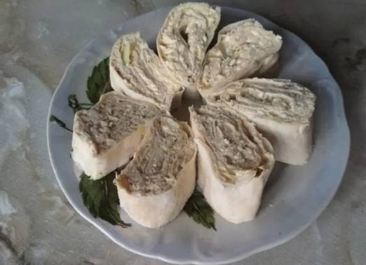 Lavash roll with canned fish, melted cheese and egg