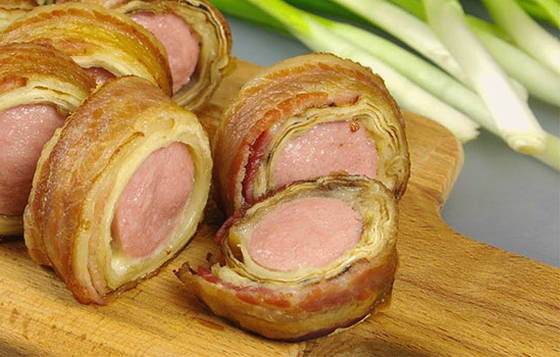 Sausages with bacon in pita bread in the oven