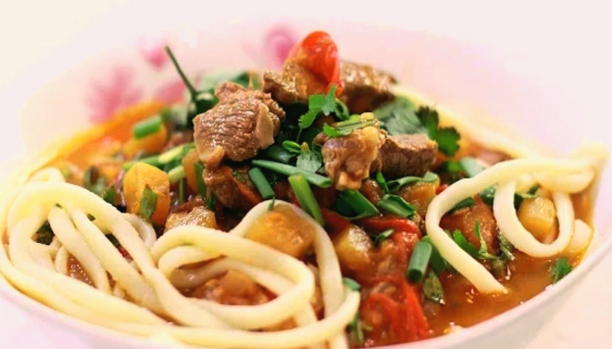 Classic Uzbek lamb lagman in a cauldron