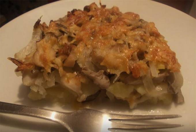 Potato casserole with chicken, cheese and mushrooms in the oven