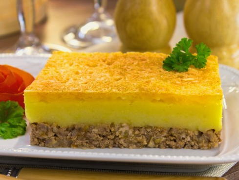 Casserole with mashed potatoes, minced meat and cheese in the oven