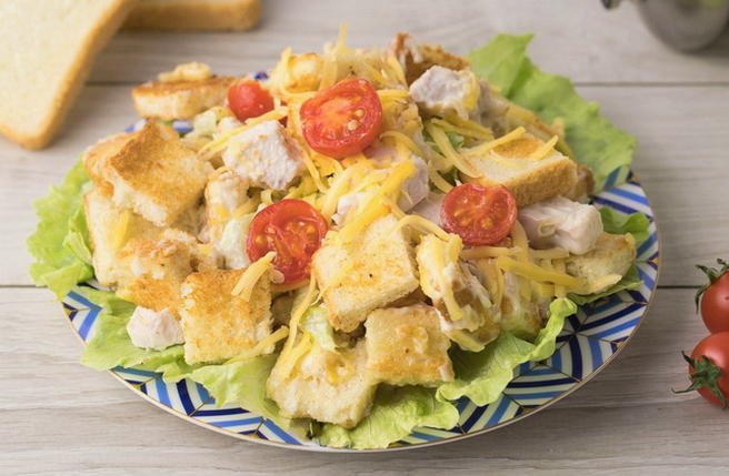 Salad with chicken, cheese, tomatoes and croutons