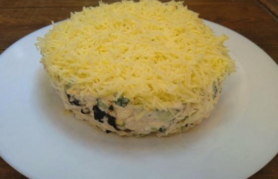 Salad with chicken, cheese, egg, cucumber and prunes