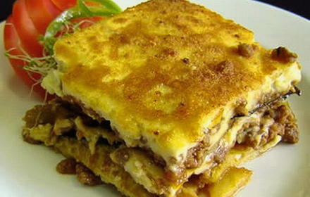 Potato casserole with minced meat, cheese and mushrooms in the oven