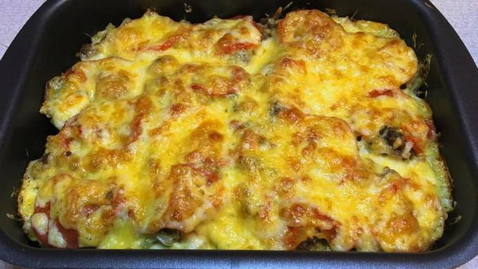 Potato casserole with minced meat, tomatoes and cheese in the oven