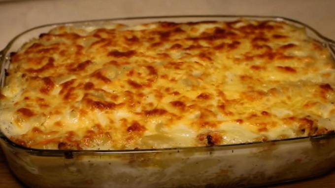 Pasta casserole with minced meat, egg and cheese in the oven