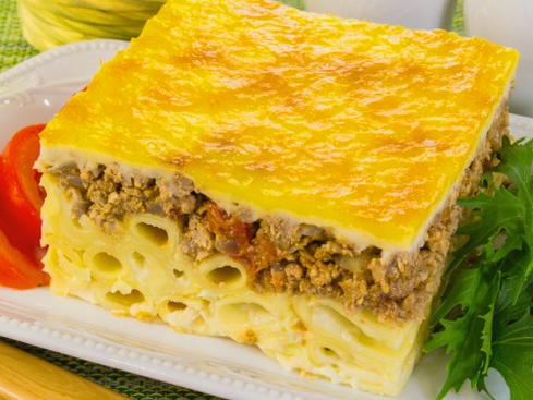 Pasta casserole with minced meat, cheese and tomatoes in the oven