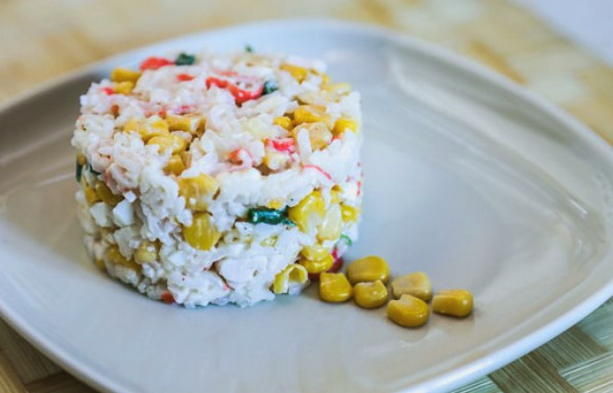 Salad with crab sticks, corn, rice and mayonnaise