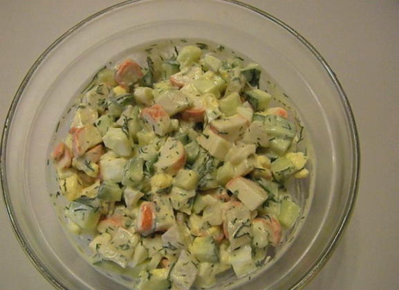 Salad with squid, crab sticks, fresh cucumber and egg