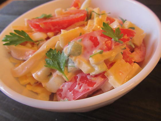 Salad with squid, tomatoes, cheese and garlic