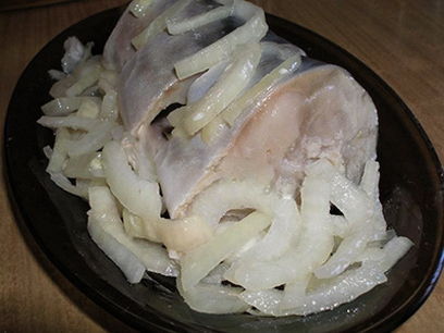 Pickled mackerel in a jar with onions