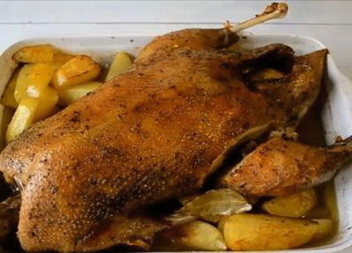 Goose with apples and potatoes in the oven
