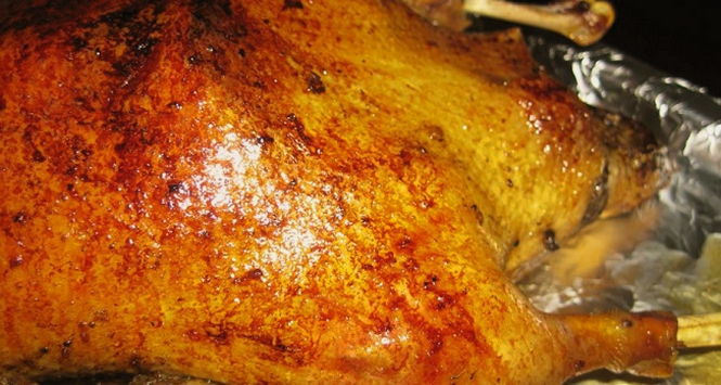 Juicy and soft goose baked in foil in the oven