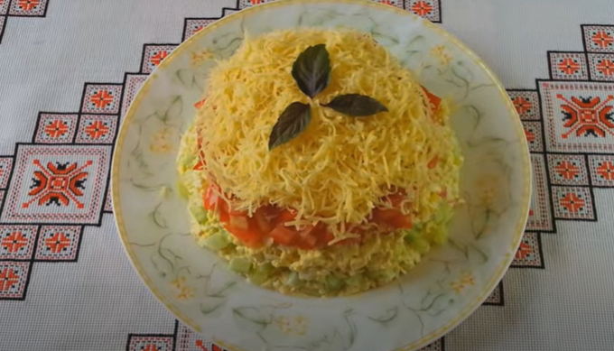 Salad with crab sticks, cucumber, tomatoes and cheese