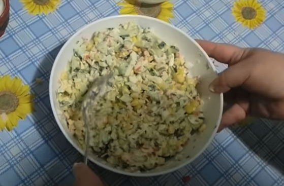 Salad with crab sticks, cucumber, cream cheese and egg