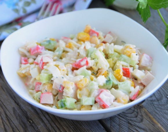Crab salad with corn, sausage, egg and cucumber