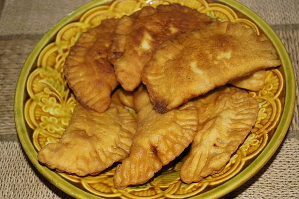 Chebureks from puff yeast dough in a pan