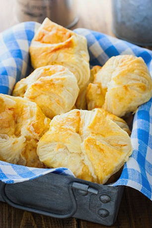 Puff pastry envelopes with cheese and ham in the oven