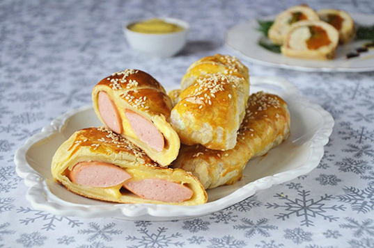 Sausages in a puff yeast-free dough with cheese in the oven
