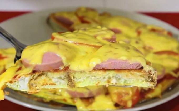 Loaf croutons with sausage, egg and milk in a pan