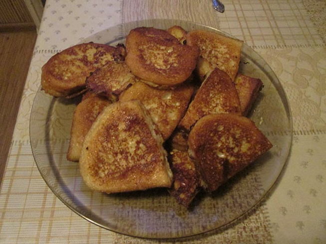 White bread croutons with egg, milk and sugar in a pan