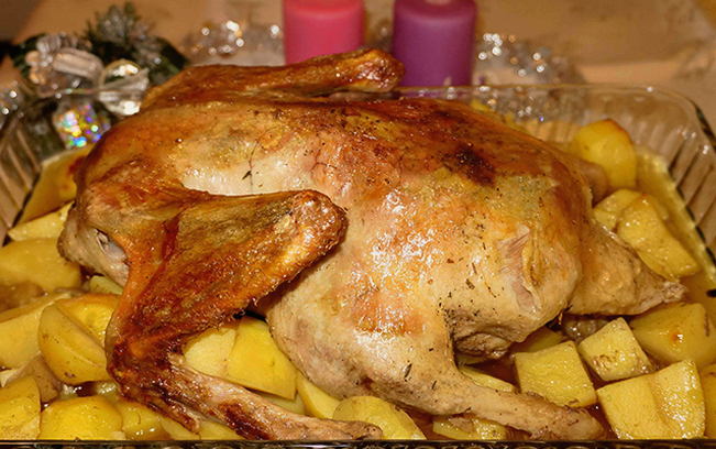 Duck with oranges and potatoes in the oven