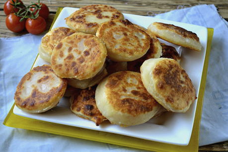 Tortillas with cheese and tomatoes in a pan