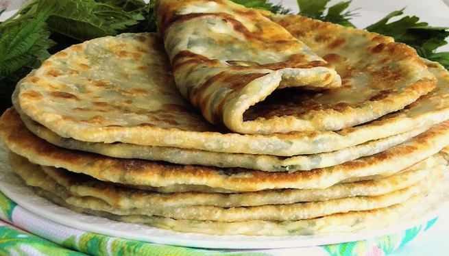 Flatbreads with Adyghe cheese and herbs in a pan