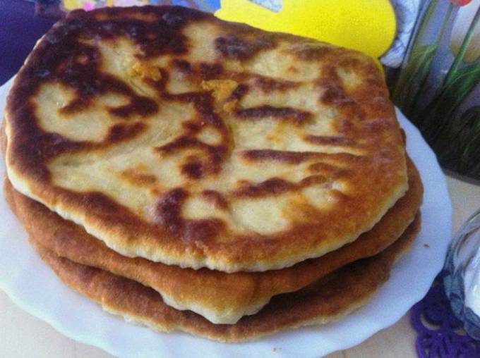 Kefir cakes with cheese and green onions in a pan