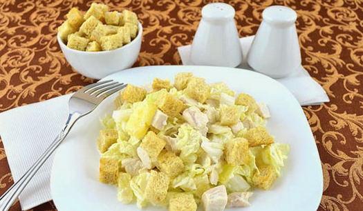 Salad with chicken, pineapple, Chinese cabbage and croutons