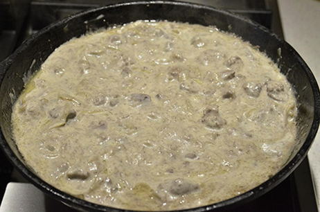 Chicken liver in sour cream with onions in a pan