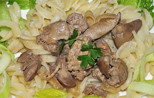 Tender chicken liver in sour cream in a pan