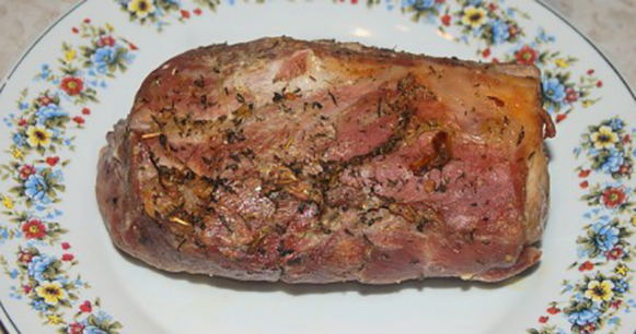 A large piece of pork baked in a sleeve in the oven